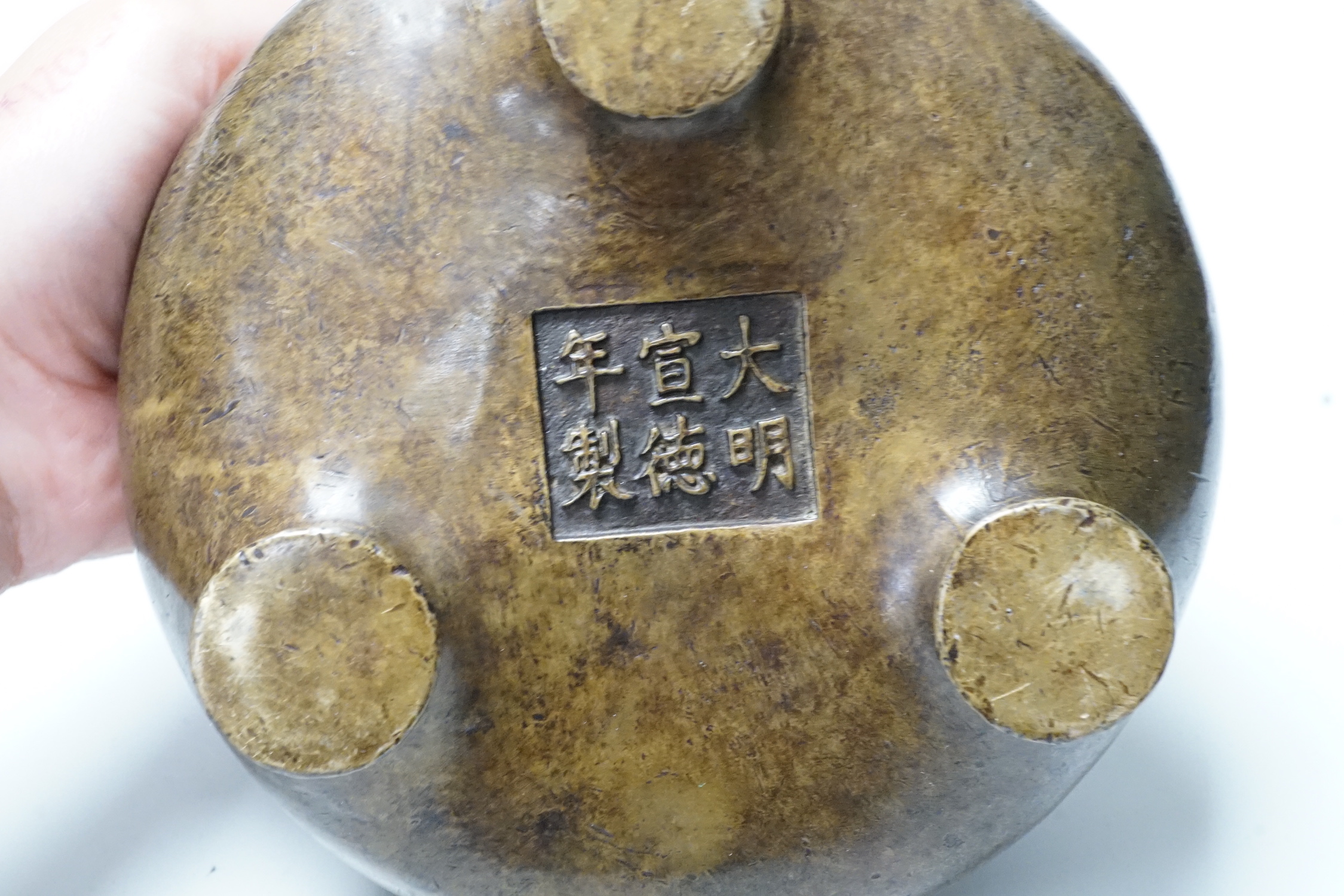 A Chinese bronze censer, ding, 14cm diameter
